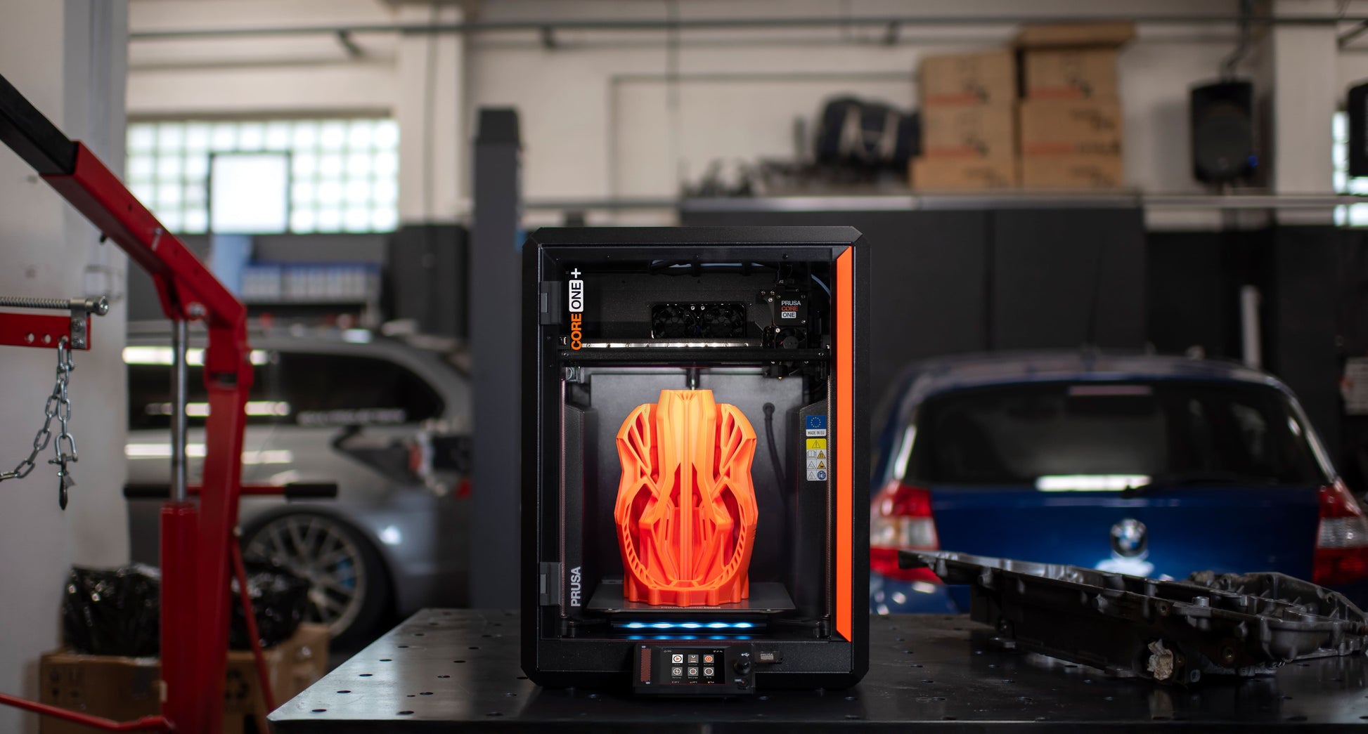 CORE One+ (Gen 2) printing in a garage workshop
