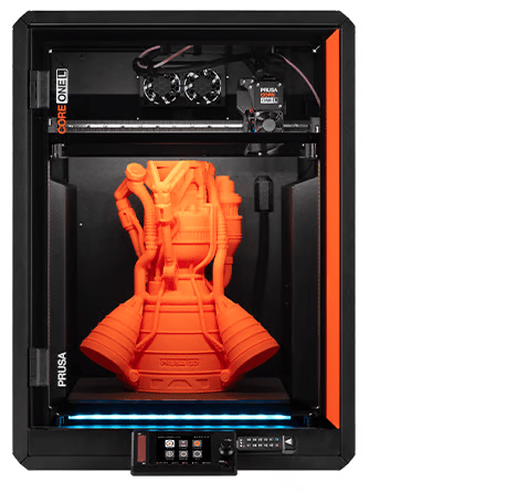 Front view of a black enclosed Prusa CORE One L 3D printer with an orange printed rocket-engine model on the build plate and a lit blue strip beneath it.